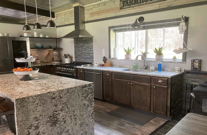 barndominium kitchen with stone counters